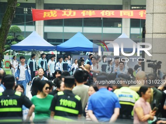 A large number of parents are greeting students coming out of a gaokao site after the 2024 National College Entrance exam in Hangzhou, China...