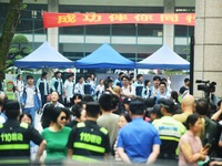 A large number of parents are greeting students coming out of a gaokao site after the 2024 National College Entrance exam in Hangzhou, China...