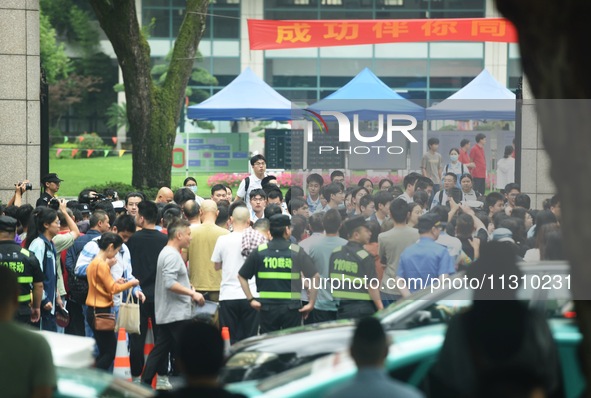 A large number of parents are greeting students coming out of a gaokao site after the 2024 National College Entrance exam in Hangzhou, China...