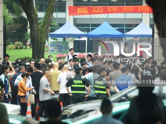 A large number of parents are greeting students coming out of a gaokao site after the 2024 National College Entrance exam in Hangzhou, China...