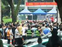 A large number of parents are greeting students coming out of a gaokao site after the 2024 National College Entrance exam in Hangzhou, China...