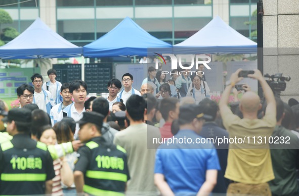 A large number of parents are greeting students coming out of a gaokao site after the 2024 National College Entrance exam in Hangzhou, China...