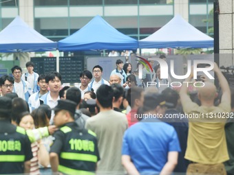 A large number of parents are greeting students coming out of a gaokao site after the 2024 National College Entrance exam in Hangzhou, China...