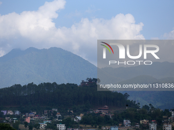 The Santaneshwor Temple, a Hindu temple, is standing tall surrounded by trees in the outskirts of Lalitpur, Nepal, on June 7, 2024. (