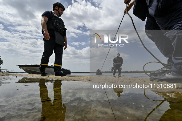 Bomb disposal experts are exploring the Dnipro River bank during the training of State Emergency Service personnel to improve their skills i...