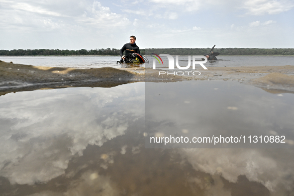 Divers are exploring the Dnipro River bank during the training of State Emergency Service personnel to improve their skills in searching for...