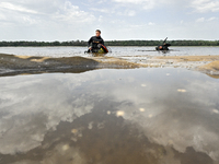 Divers are exploring the Dnipro River bank during the training of State Emergency Service personnel to improve their skills in searching for...