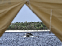 Divers are riding a boat across the Dnipro River during the training of State Emergency Service personnel to improve their skills in searchi...