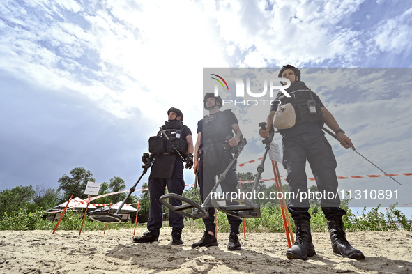 Bomb disposal experts are exploring the Dnipro River bank with metal detectors during the training of State Emergency Service personnel to i...