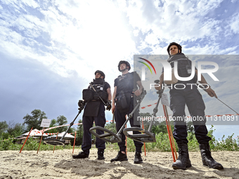 Bomb disposal experts are exploring the Dnipro River bank with metal detectors during the training of State Emergency Service personnel to i...