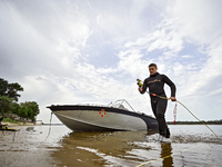 A diver is wading out of the Dnipro River during the training of State Emergency Service personnel to improve their skills in searching for...