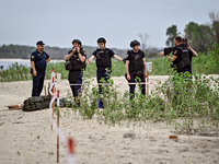 Bomb disposal experts are exploring the Dnipro River bank during the training of State Emergency Service personnel to improve their skills i...