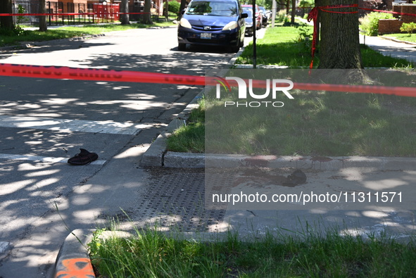 Shoes, blood, and clothing are being found at the crime scene. Two people are being shot in Chicago, Illinois, United States, on June 7, 202...