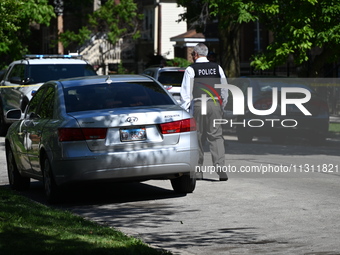 Chicago police are gathering at the crime scene and investigating the shooting that is seriously injuring a 55-year-old man in Chicago, Illi...