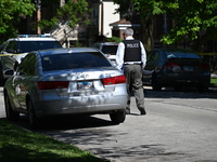 Chicago police are gathering at the crime scene and investigating the shooting that is seriously injuring a 55-year-old man in Chicago, Illi...