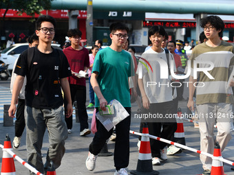 Candidates are lining up to enter a test room to take the National college entrance examination at a college entrance examination site in Fu...