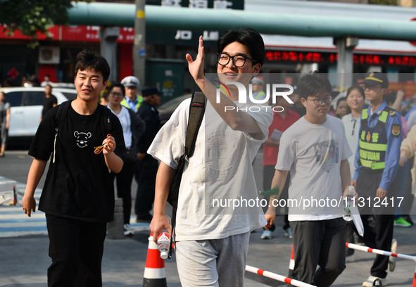 Candidates are lining up to enter a test room to take the National college entrance examination at a college entrance examination site in Fu...