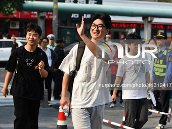 Candidates are lining up to enter a test room to take the National college entrance examination at a college entrance examination site in Fu...