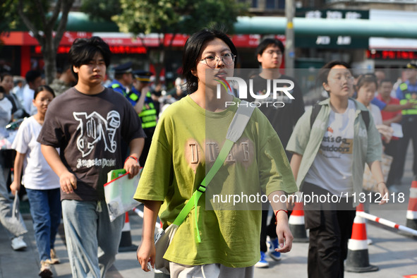 Candidates are lining up to enter a test room to take the National college entrance examination at a college entrance examination site in Fu...