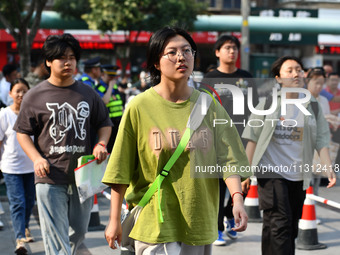 Candidates are lining up to enter a test room to take the National college entrance examination at a college entrance examination site in Fu...