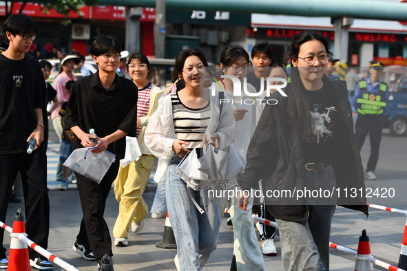 Candidates are lining up to enter a test room to take the National college entrance examination at a college entrance examination site in Fu...