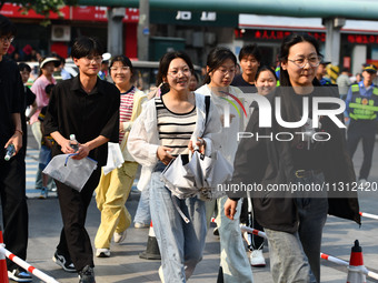 Candidates are lining up to enter a test room to take the National college entrance examination at a college entrance examination site in Fu...