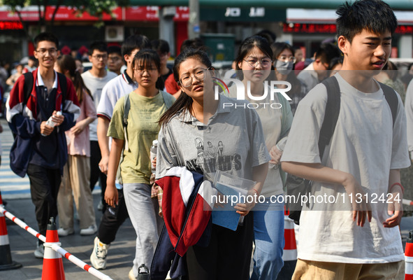 Candidates are lining up to enter a test room to take the National college entrance examination at a college entrance examination site in Fu...