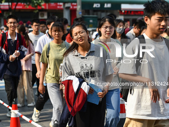 Candidates are lining up to enter a test room to take the National college entrance examination at a college entrance examination site in Fu...