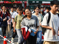 Candidates are lining up to enter a test room to take the National college entrance examination at a college entrance examination site in Fu...