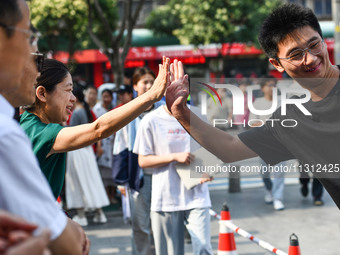 Candidates are lining up to enter a test room to take the National college entrance examination at a college entrance examination site in Fu...