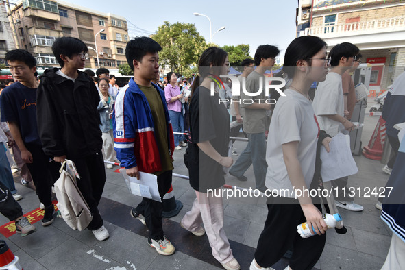 Candidates are lining up to enter a test room to take the National college entrance examination at a college entrance examination site in Fu...