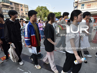 Candidates are lining up to enter a test room to take the National college entrance examination at a college entrance examination site in Fu...