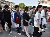 Candidates are lining up to enter a test room to take the National college entrance examination at a college entrance examination site in Fu...