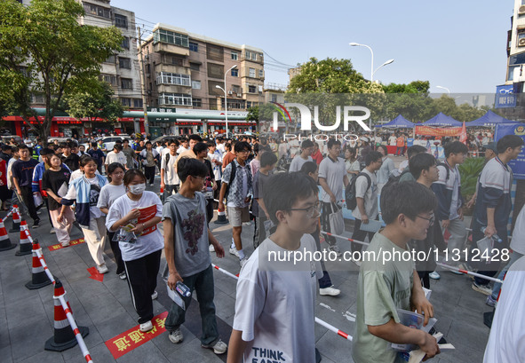 Candidates are lining up to enter a test room to take the National college entrance examination at a college entrance examination site in Fu...