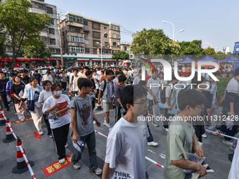 Candidates are lining up to enter a test room to take the National college entrance examination at a college entrance examination site in Fu...