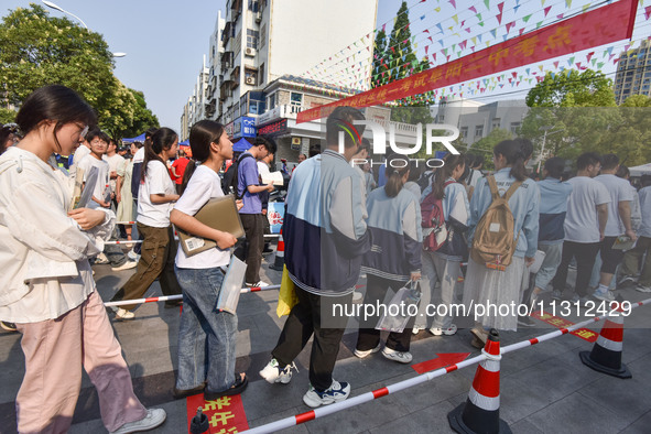 Candidates are lining up to enter a test room to take the National college entrance examination at a college entrance examination site in Fu...