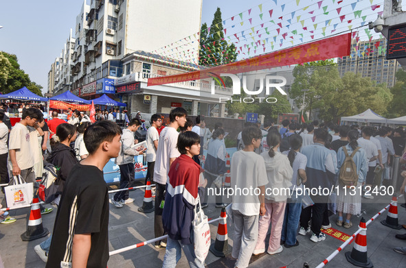 Candidates are lining up to enter a test room to take the National college entrance examination at a college entrance examination site in Fu...