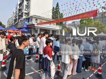 Candidates are lining up to enter a test room to take the National college entrance examination at a college entrance examination site in Fu...