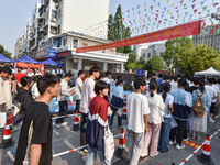 Candidates are lining up to enter a test room to take the National college entrance examination at a college entrance examination site in Fu...