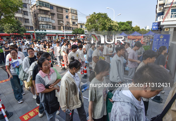 Candidates are lining up to enter a test room to take the National college entrance examination at a college entrance examination site in Fu...