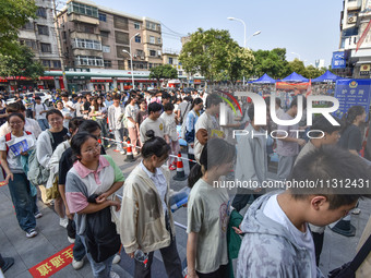 Candidates are lining up to enter a test room to take the National college entrance examination at a college entrance examination site in Fu...