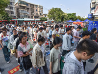 Candidates are lining up to enter a test room to take the National college entrance examination at a college entrance examination site in Fu...