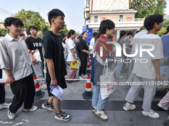 Candidates are lining up to enter a test room to take the National college entrance examination at a college entrance examination site in Fu...