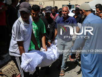 Palestinian mourners are carrying the body of a victim of Israeli bombardment outside a hospital in Deir el-Balah, in the central Gaza Strip...