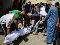 Palestinian mourners are carrying the body of a victim of Israeli bombardment outside a hospital in Deir el-Balah, in the central Gaza Strip...