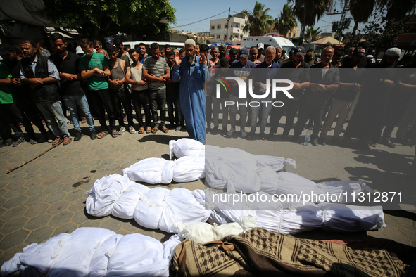 Palestinians are mourning over the bodies of victims of Israeli bombardment outside a hospital in Deir el-Balah in the central Gaza Strip, o...