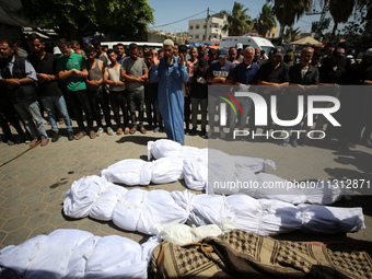 Palestinians are mourning over the bodies of victims of Israeli bombardment outside a hospital in Deir el-Balah in the central Gaza Strip, o...