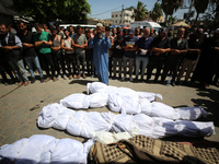 Palestinians are mourning over the bodies of victims of Israeli bombardment outside a hospital in Deir el-Balah in the central Gaza Strip, o...