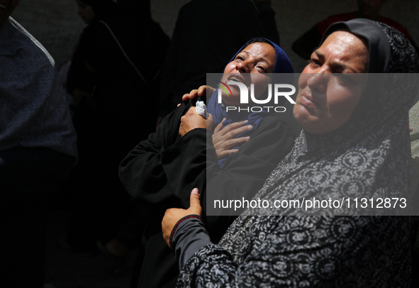 Palestinian women are mourning the death of loved ones following Israeli bombardment, outside a hospital in Deir el-Balah in the central Gaz...