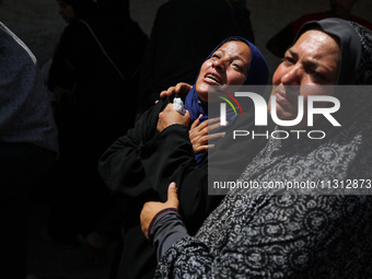 Palestinian women are mourning the death of loved ones following Israeli bombardment, outside a hospital in Deir el-Balah in the central Gaz...